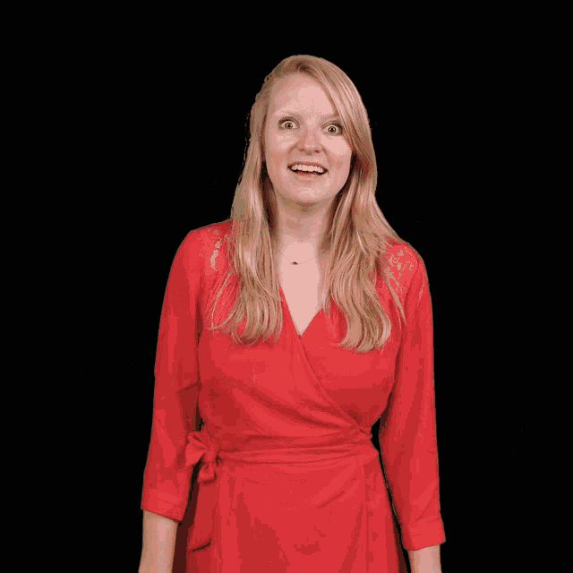 a woman in a red dress giving a thumbs up