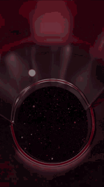 a close up of a glass container with a purple liquid in it