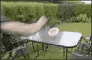 a person is sitting at a table with a bowl on top of it .