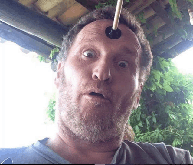 a man with a puck sticking out of his forehead makes a funny face