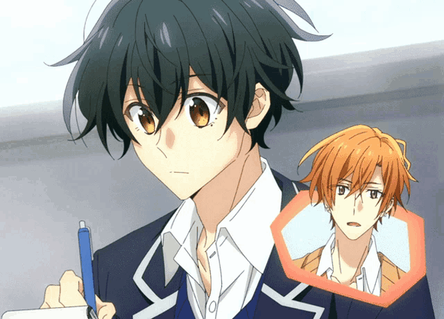 a boy with a pen in his hand looks at another boy