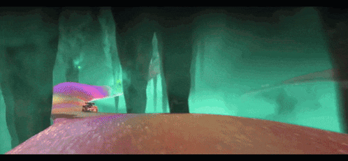 a car is driving through a dark cave with a rainbow in the background