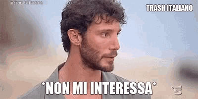 a man with a beard is looking at the camera and says `` non mi interessa '' in italian .