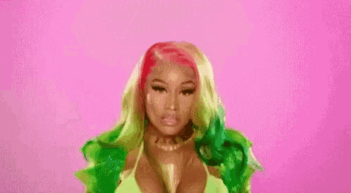 a woman with red hair and a green jacket is taking off her bra .