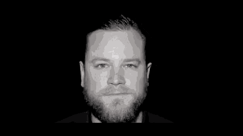 a man with a beard has a clown makeup on his face