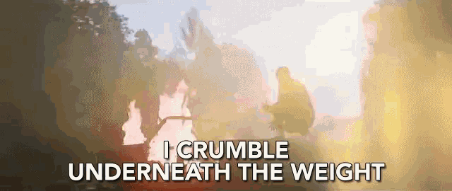 a man stands in front of a fire with the words i crumble underneath the weight