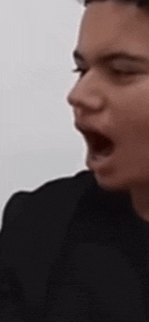 a close up of a person with their mouth open .
