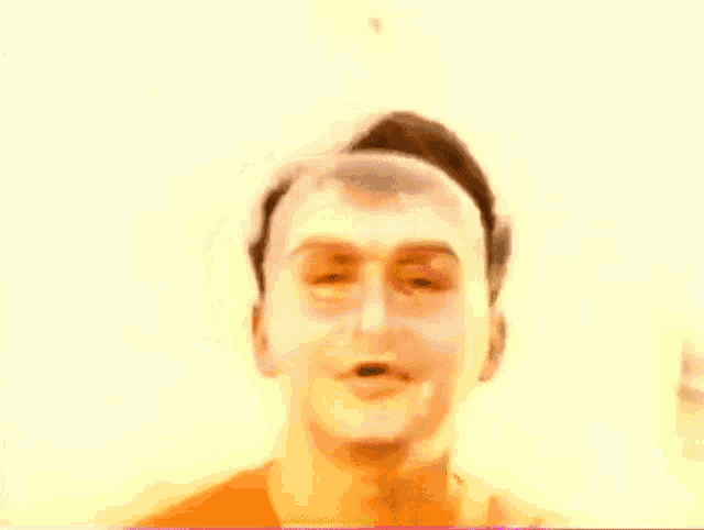 a man with white paint on his face looks at the camera with his eyes closed