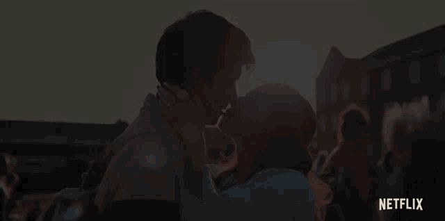a man and woman kissing in front of a netflix sign