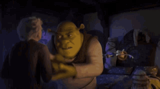 shrek is holding a puppet in his hand and shrek is looking at the puppet