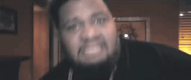 a man is making a funny face in a living room .
