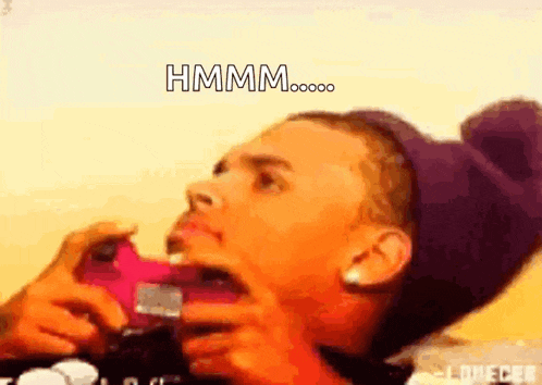 a man in a purple hat is taking a picture with his mouth open and the words hmmm written above him
