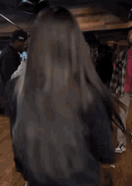 a woman in a very revealing black shirt is dancing in a crowd