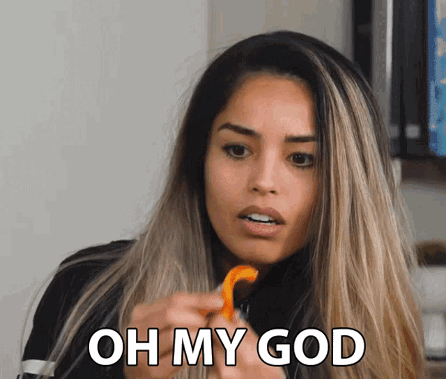a woman eating a slice of orange with the words oh my god written on the bottom