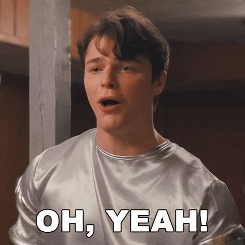 a man in a silver shirt says oh yeah in white letters
