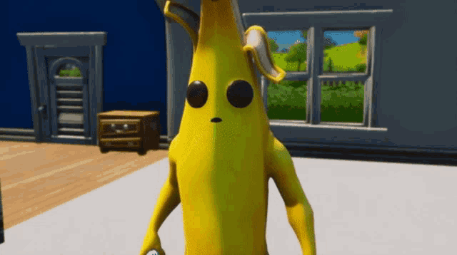 a yellow banana with black eyes standing in a room