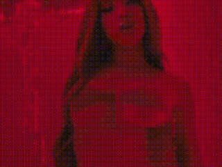 a woman is standing in a red room with a red background .