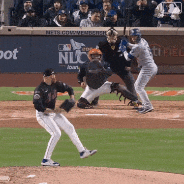 a baseball game is being played in front of a nlc sign