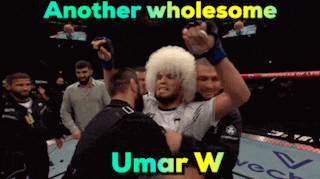 another wholesome umar w is being hugged by a man in a boxing ring