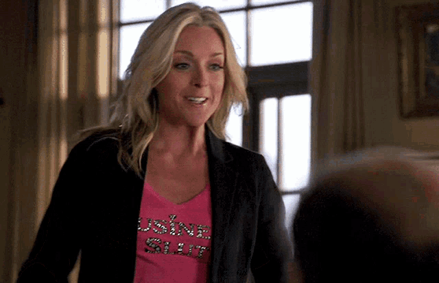 a woman wearing a pink shirt that says " using sharp "