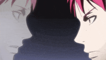 a man with red hair looks at his reflection in the mirror