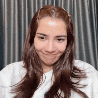 a woman with long hair is making a funny face .