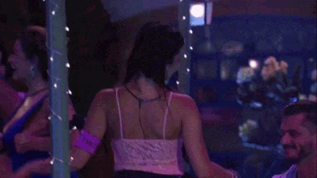 a man and woman are dancing in a dark room