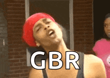 a man wearing a red headband and a black tank top with gbr written on it
