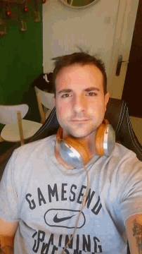 a man wearing headphones and a shirt that says samesend rafting