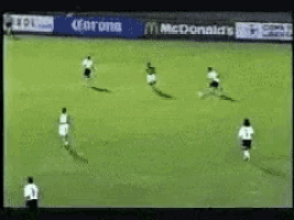 a soccer game is being played in front of a corona and mcdonald 's sign