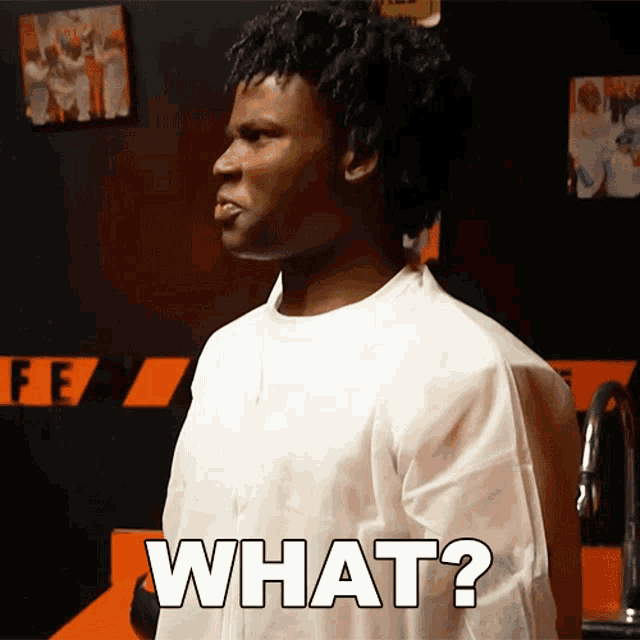 a man in a white shirt says what in black letters