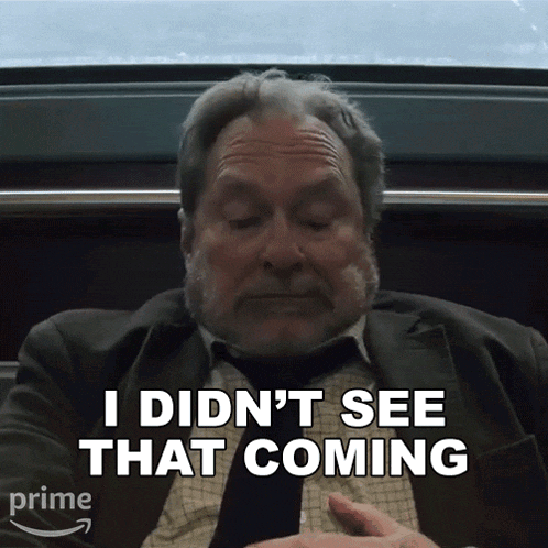a man in a suit and tie is saying " i didn 't see that coming "