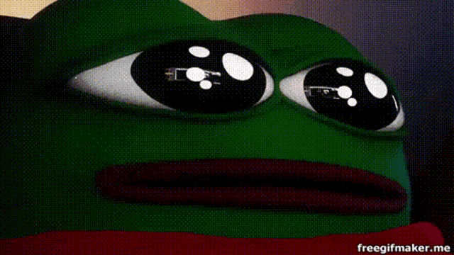 a frog is laying on a bed with a green blanket and red sheets .