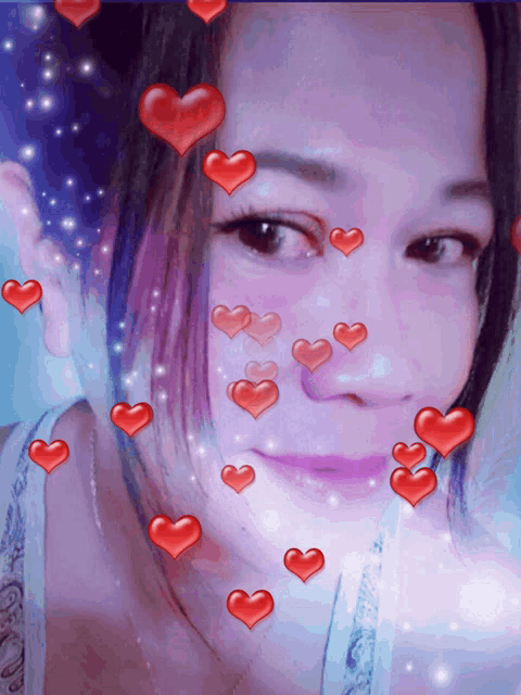 a woman 's face is surrounded by red hearts and sparkles