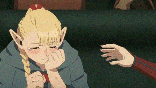 a girl with blonde hair is crying and a hand is reaching out to touch her face