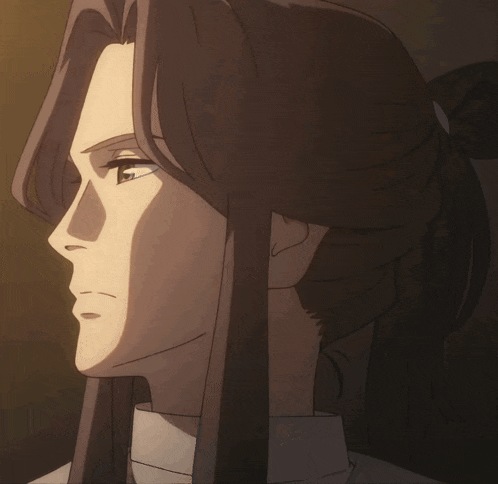 a close up of a person 's face with long hair and a ponytail