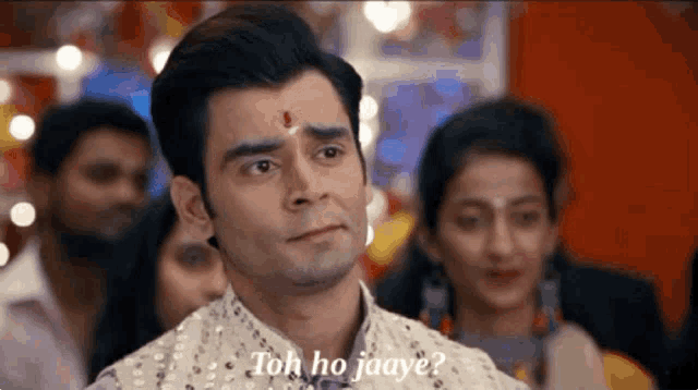 a man says " toh ho jaaye " in front of a crowd of people