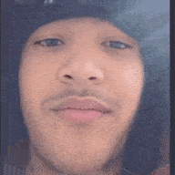 a close up of a man 's face with a hat on his head