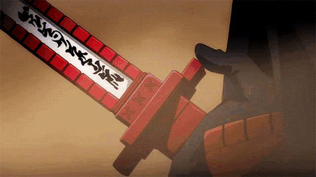 a person is holding a red and white sword with chinese writing on it