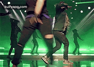 a group of people are dancing on a stage .