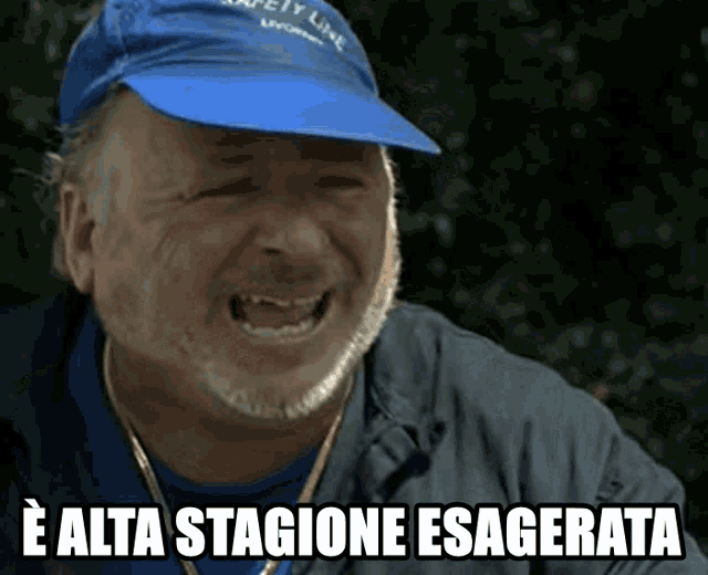 a man wearing a blue hat with the words safety line on it laughs