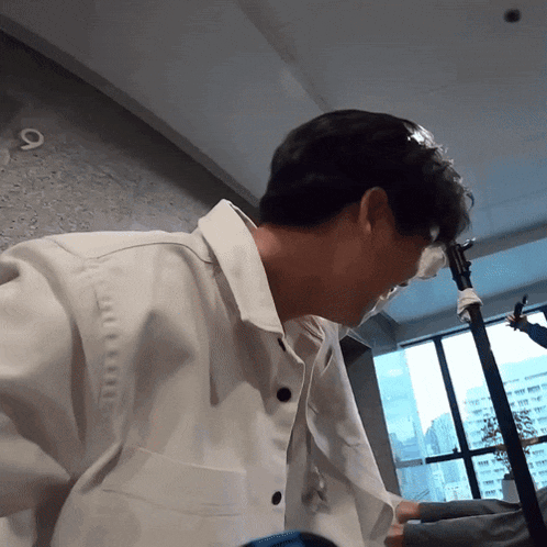 a man wearing a white shirt has a bandage on his face