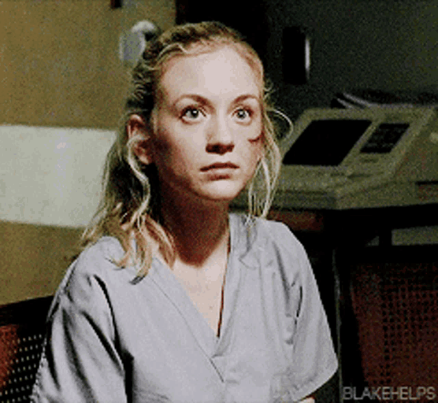 a woman in a scrub top with blakehelps written on the bottom right