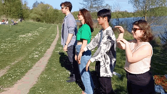 a group of people standing next to each other on a path