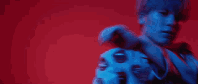 a blurry picture of a man in a blue and red light .