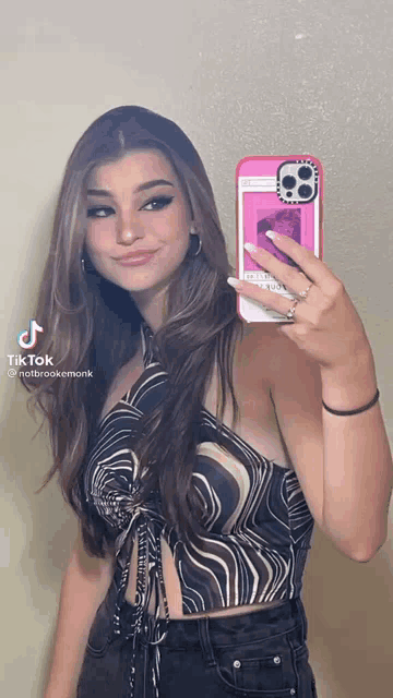 a woman is taking a selfie with a case that says casetify