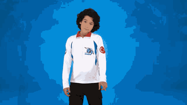 a young boy wears a white shirt with a dolphin on the front