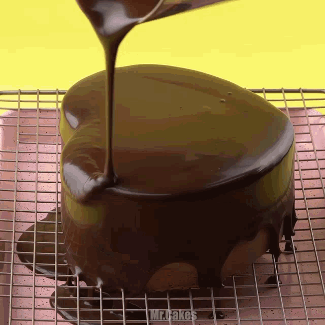 a cake is covered in chocolate and the words mr.bakes are visible