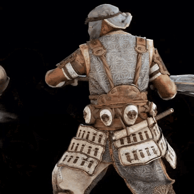 the back of a samurai with a sword and a helmet