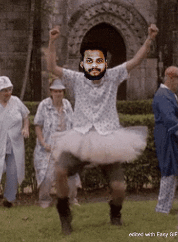 a man with a beard is wearing a tutu and dancing
